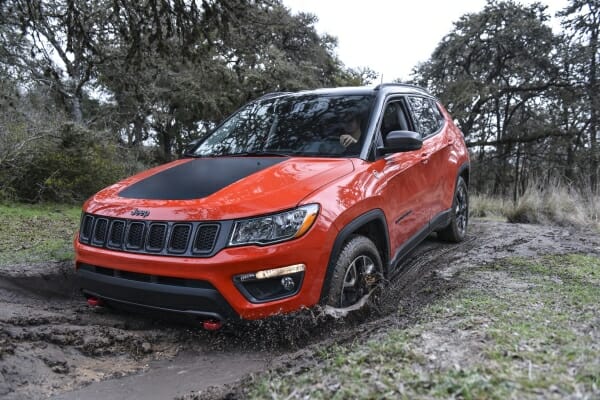 red 2019 Jeep Compass in mud